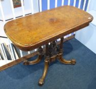 A Victorian walnut fold over card table with quarter marquetry top and green baize, supported on