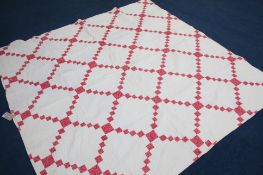A quilted patchwork quilt with floral paisley reverse and outer border, and a white Durham quilt