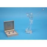 A Baccarat clear glass figure of a Golfer and a pair of boxed Lalique 'Oxygene' cuff links.