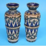A pair of Doulton Lambeth Stoneware vases decorated with two bands of stylised flowers, of