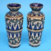 A pair of Doulton Lambeth Stoneware vases decorated with two bands of stylised flowers, of