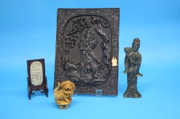A Chinese carved wood panel decorated with a warrior; a 20th century carved jade inset panel on a