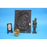 A Chinese carved wood panel decorated with a warrior; a 20th century carved jade inset panel on a