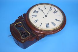 A Victorian mahogany cased circular wall clock with painted dial.  43 cm diameter, 62 cm long.