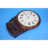 A Victorian mahogany cased circular wall clock with painted dial.  43 cm diameter, 62 cm long.