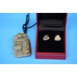 A pair of 9ct gold (tested) stud earrings set with small diamonds and a carved jade pendant.