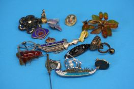 A yellow metal fob with greyhound, two other fobs, seven silver brooches and seven brooches,