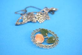A gold coloured brooch set with carved coral rosehead and jade leaves and a 1920's marcasite and