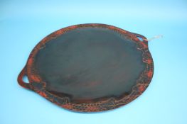 A large circular two handled lacquered tray.  68 cm diameter