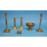 A 19th century brass two handled urn decorated with figure heads supported on a pedestal base; a