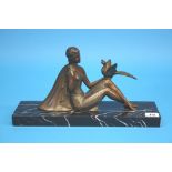 A 1930's Art Deco Spelter figure of a lady seated with a bird balanced on her left hand, supported