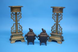 A small pair of bronze censors and a pair of Oriental candlesticks with pierced fretwork sides.