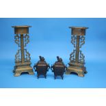 A small pair of bronze censors and a pair of Oriental candlesticks with pierced fretwork sides.