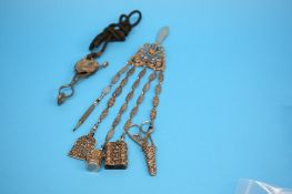 A late Victorian Chatelaine with various etuis attached and an ornate clamp. (2)