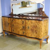 An Italian walnut mirror back sideboard with glass inset top, the serpentine front with three