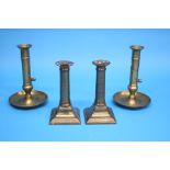 Two pairs of brass candlesticks.