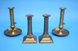 Two pairs of brass candlesticks.