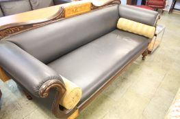 A mahogany marquetry inlaid scroll end settee supported in fluted and reeded legs.