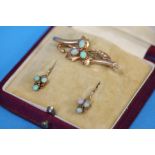 A gold pierced bar brooch set with three small opals, a pair of gold and opal earrings and a