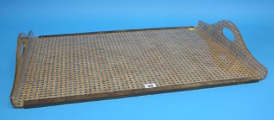 A 1970's Christian Dior Lucite tray with brass galleries and rattan cane-work.  50 cm wide, 72 cm