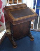 A Victorian walnut Davenport with domed and rising top, four frieze drawers and platform base with