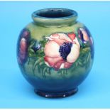 A Moorcroft globular shaped vase "Big Poppy" pattern on a graduated green and blue ground.