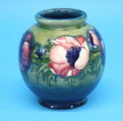 A Moorcroft globular shaped vase "Big Poppy" pattern on a graduated green and blue ground.