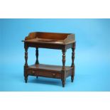 A miniature Victorian mahogany washstand with raised back, the central recess below a single drawer,