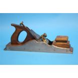 A Norris of London brass, wood and steel wood plane, stamped Norris, London.  38 cm long