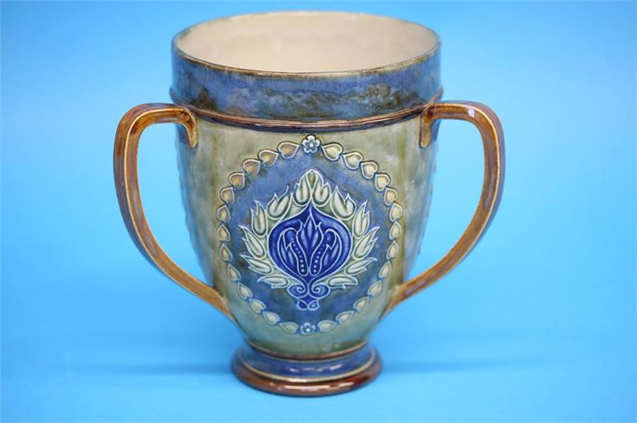 A Royal Doulton stoneware tyg decorated with three panels of stylised flowers, impressed marks,