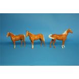 Three Beswick Palomino horses.