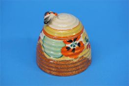 A Clarice Cliff Bizarre 'Nasturtium' pattern beehive shape honey pot and cover, black printed mark.