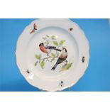 A Meissen plate, the centre decorated with birds, the border with butterflies and insects, cross