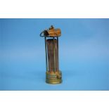 An early brass Miner's lamp by Laidler of Durham with hinged hood and iron gauze.  20.5 cm high