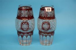 A pair of early 20th century Bohemian red flashed and hob nail cut glass vases.  22 cm high