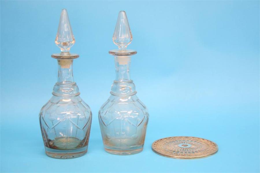 A pair of Georgian glass decanters with conical facet cut stoppers and cut glass and facet cut