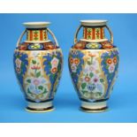 A pair of Noritake vases with gilt looped handles decorated with colourful flowers on a yellow and