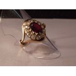 9ct gold ring set with central garnet set with white stones. Size N
