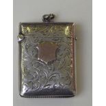 Late Victorian Silver Vesta case of curved rectangular form, Profuse foliate scrolls surrounding a
