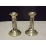 Pair of silver dwarf candlesticks of column form. Birmingham 1919. 11cm in hight. Loaded bases