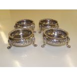 Set of Four Victorian silver open salts, repousse decorated, raised on three paw feet, personal