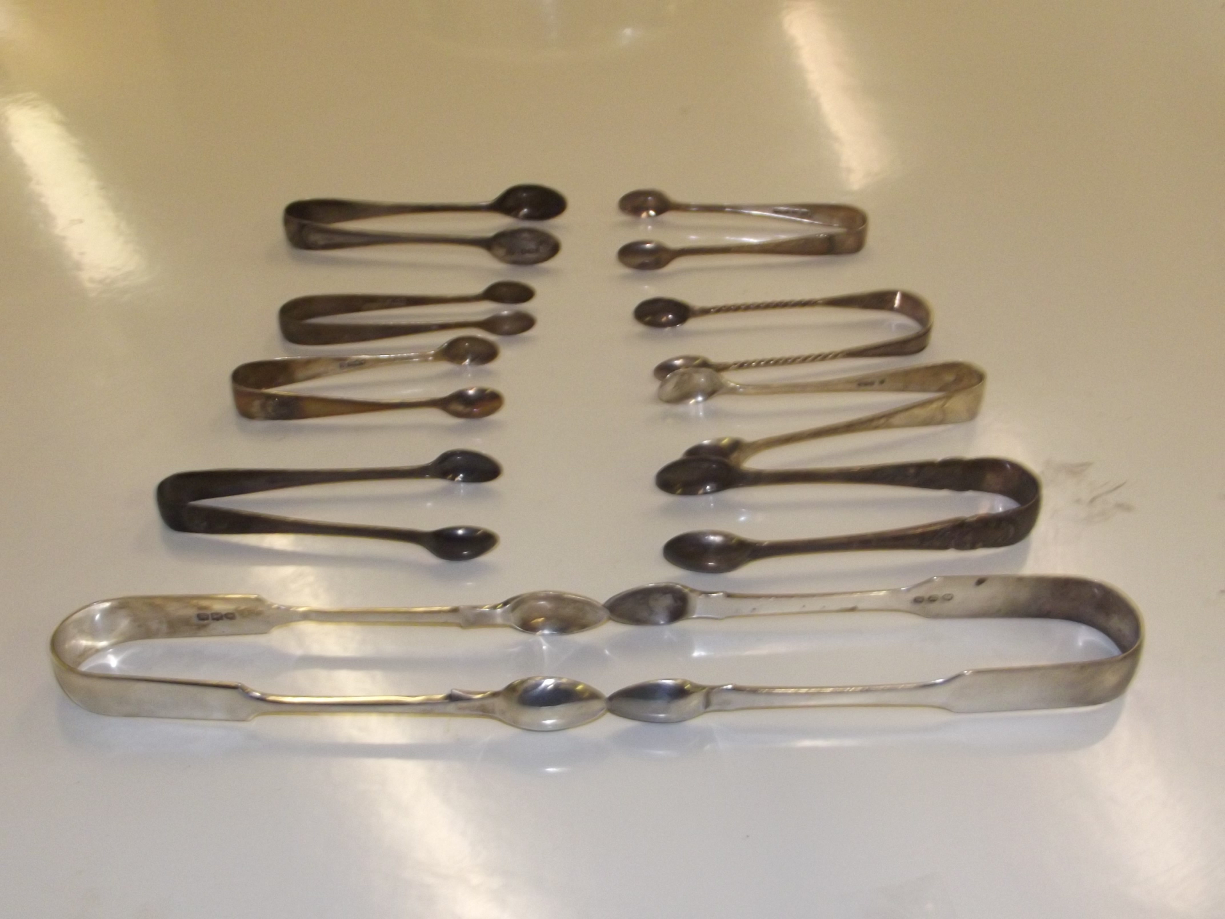 Group of 10 assorted Silver Sugar Tongs, Predominantly early 20th century, 2 of which are 19th
