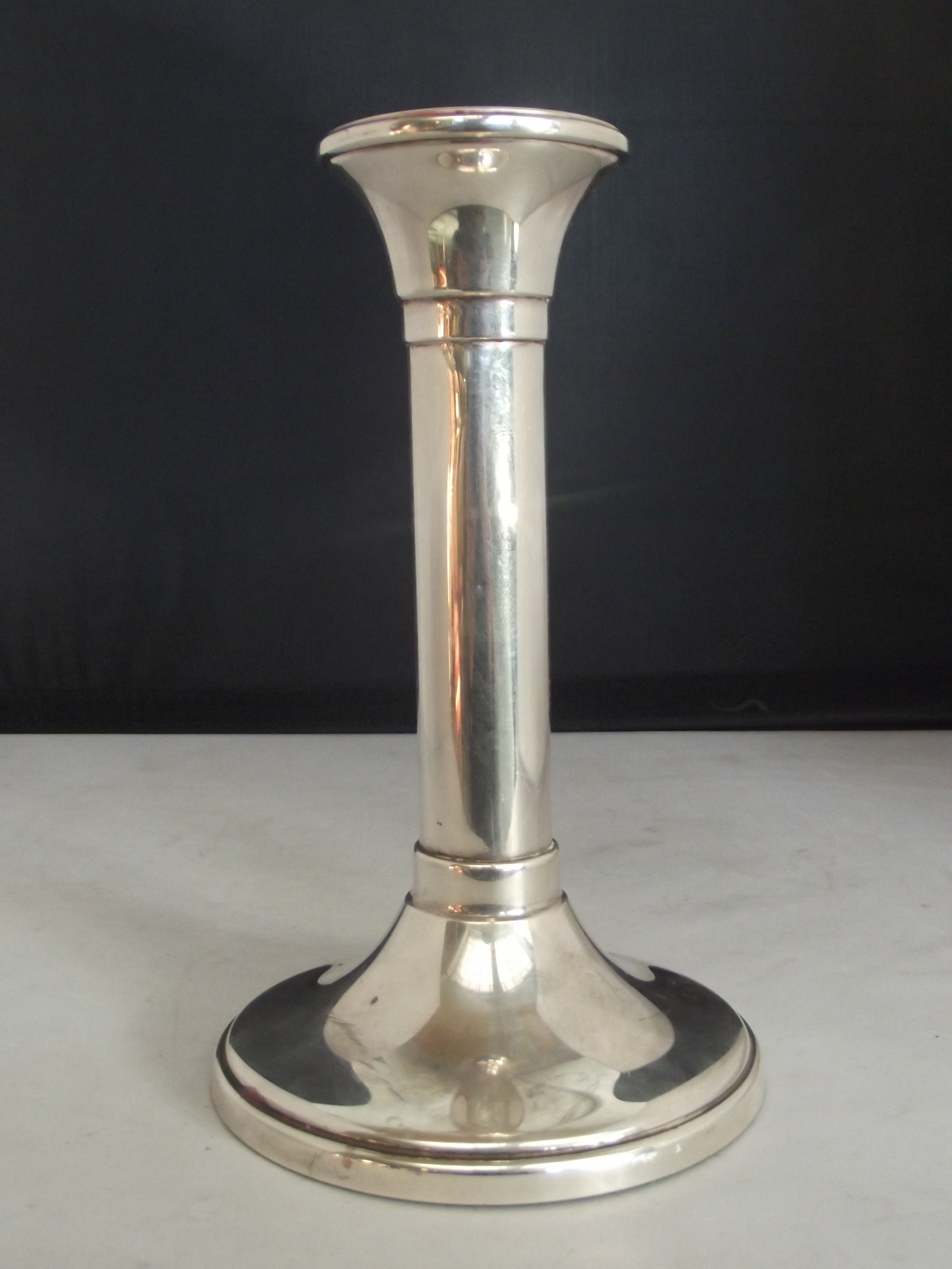 Silver candlestick of plain column form on a circular speading base. Carr's of Sheffield, 2005, 17cm