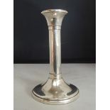 Silver candlestick of plain column form on a circular speading base. Carr's of Sheffield, 2005, 17cm