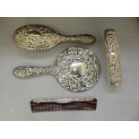 Four Piece matched silver dressing table set, comprising of hand mirror, hair brush, clothes brush