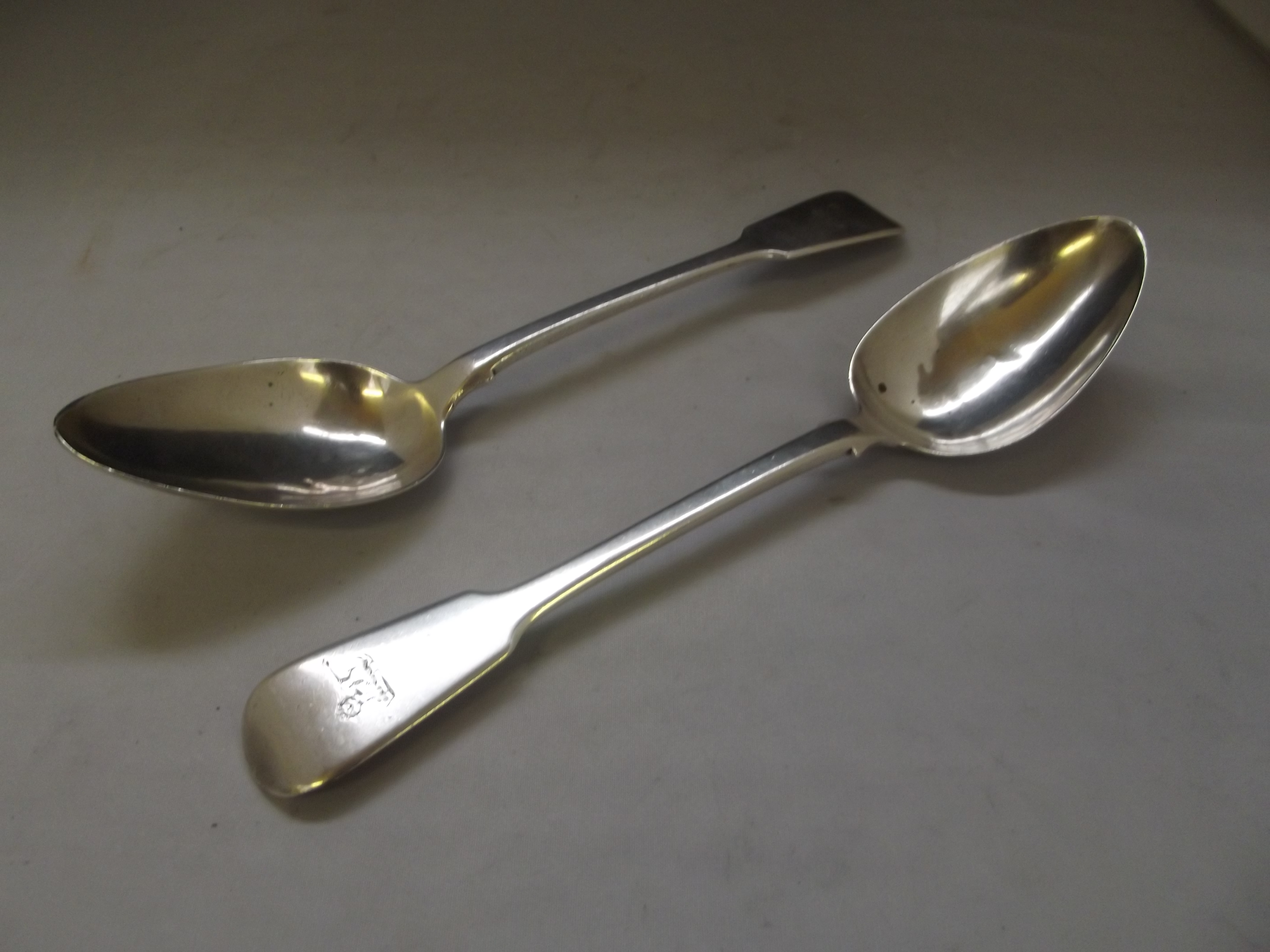 Pair of George III silver fiddle pattern tablespoons with lion engraved terminals, London, 1819,