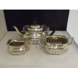 Edwardian Silver three piece tea service with gadrooned bodies and raised handles, Birmingham