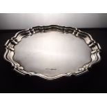 Edwardian silver salves of shaped and stepped circular form, raised on three scroll feet.