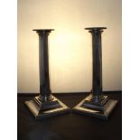 Pair of silver candlesticks of octagonal column form on square beaded bases with detachable sconces.