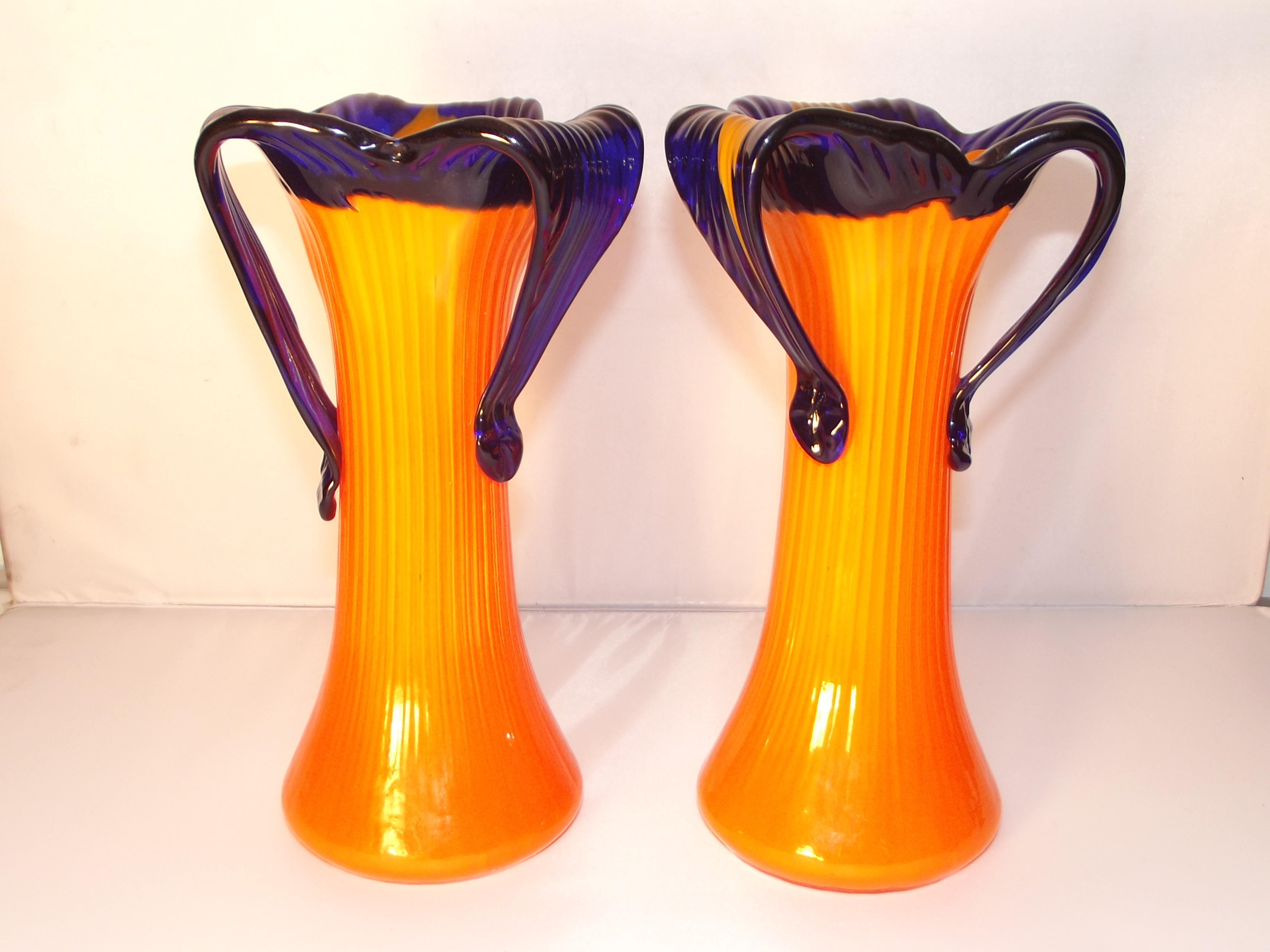 A pair of 1950/60s glass vases. Unusual shape and style with orange and cobalt blue. 20cm high